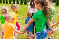 Children holding hands and standing in circle